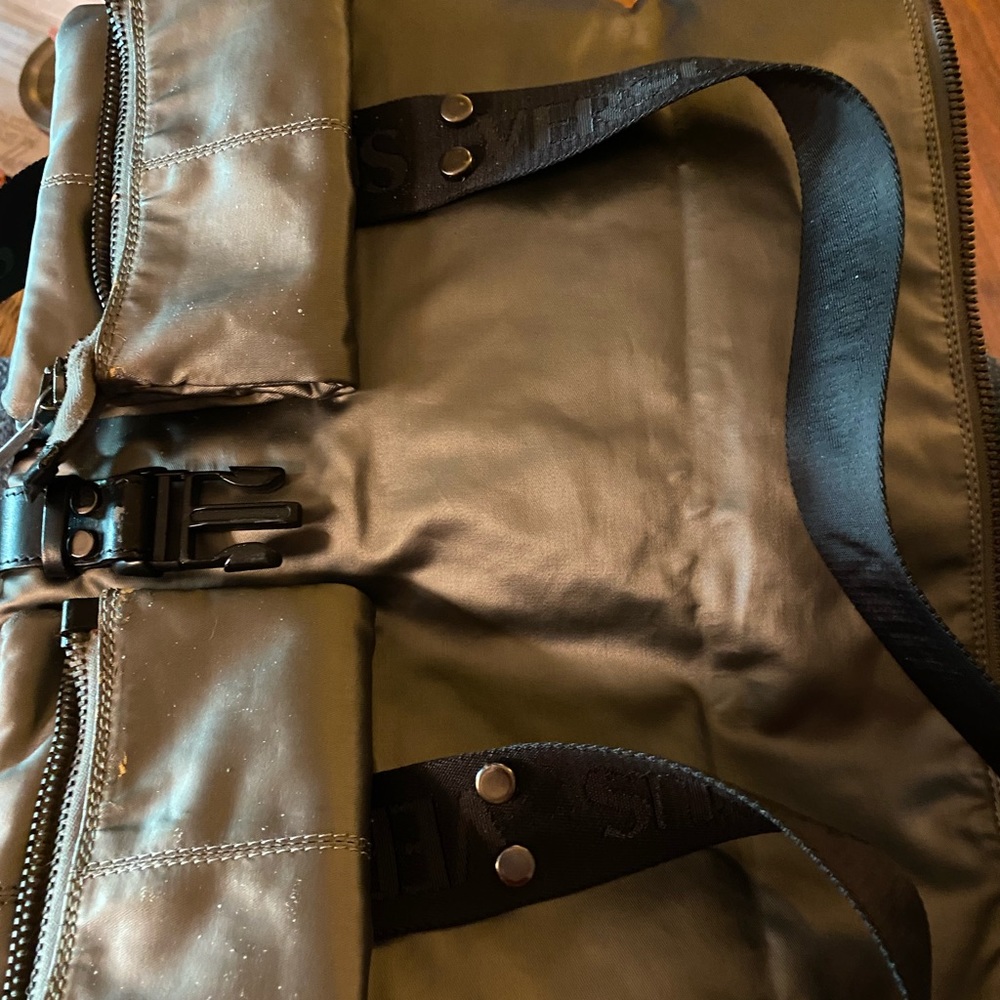 VERSUS by Versace, bag which folds over or can be carried with out folding.